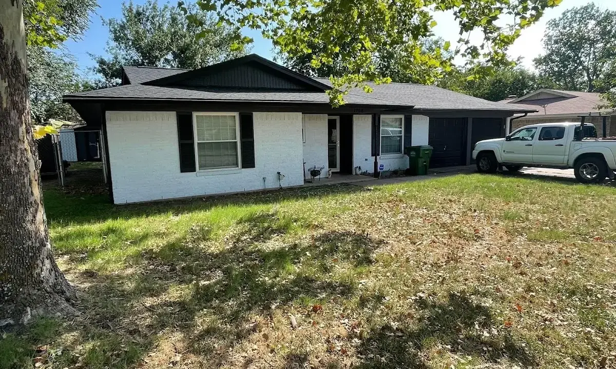 Professional roofing crew working on a residential roof in Tarrytown